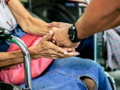 man holding hand with woman on chair